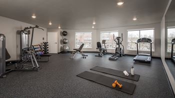 A spacious home gym with a variety of exercise equipment.